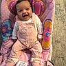 baby, infant, child, smiling, happy, portrait, seated, indoor, pink, clothing, overalls, booties, baby_seat, cushion, colorful, playful, face, floor, furniture, photography
