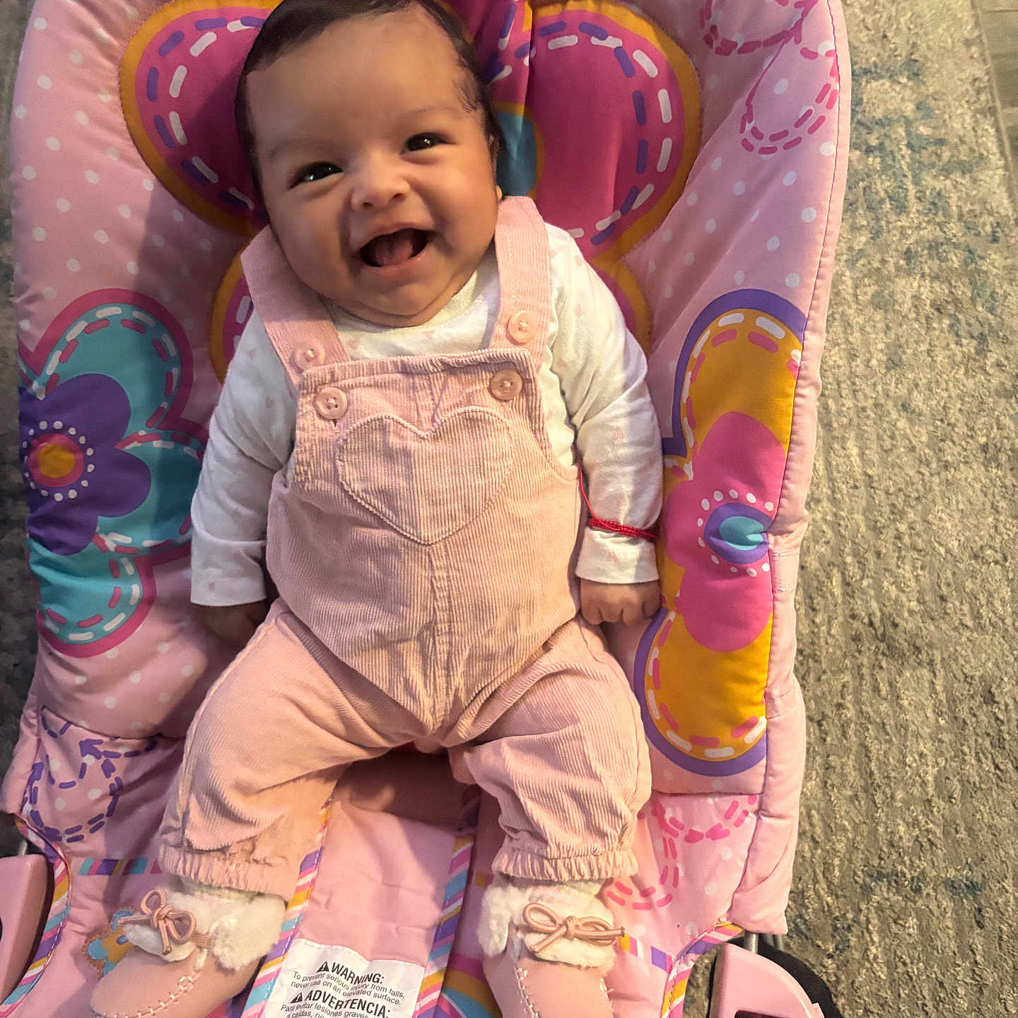 Amiri Lopez joined the competition — help win amazing prizes! baby, infant, child, smiling, happy, portrait, seated, indoor, pink, clothing, overalls, booties, baby_seat, cushion, colorful, playful, face, floor, furniture, photography