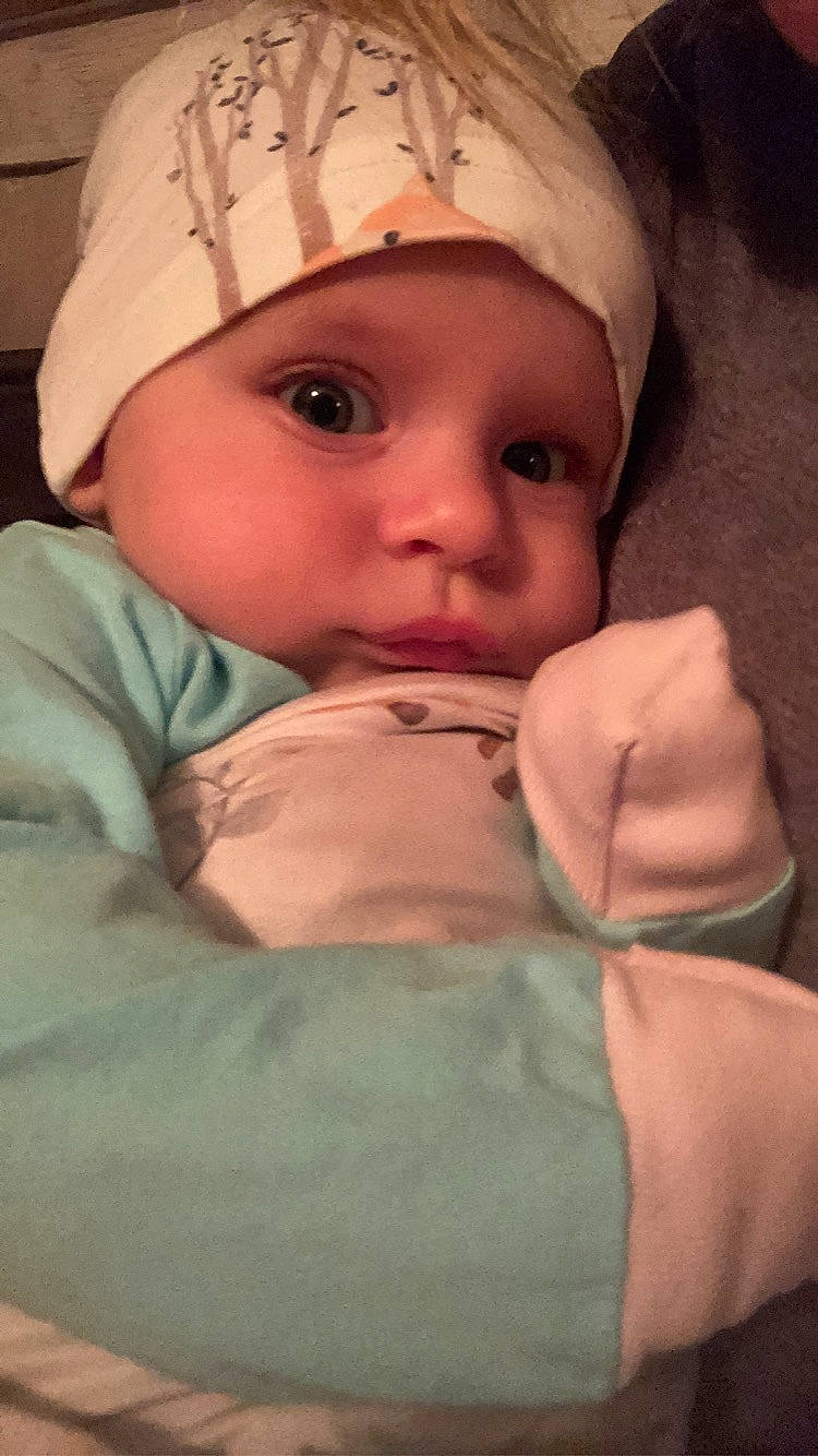 Adley is registered to the contest to win money with this photo: baby, cap, cheek, eye, eyebrow, eyelash, face, finger, forehead, gesture, head, headgear, headwear, human_body, iris, lip, mouth, nose, outerwear, person