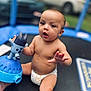 baby, child, diaper, toy, trampoline, outdoor, infant, play, cute, skin, hand, face, expression, sitting, background, blur, car, greenery, summer, fun