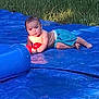 Colby is registered to the contest to win money with this photo: toddler, child, outdoor, grass, blue_tarp, toy, red_toy, bare_chest, shorts, summer, sunlight, playing, lying_down, curious, baby, nature, relaxing, daylight, barefoot, grass_field