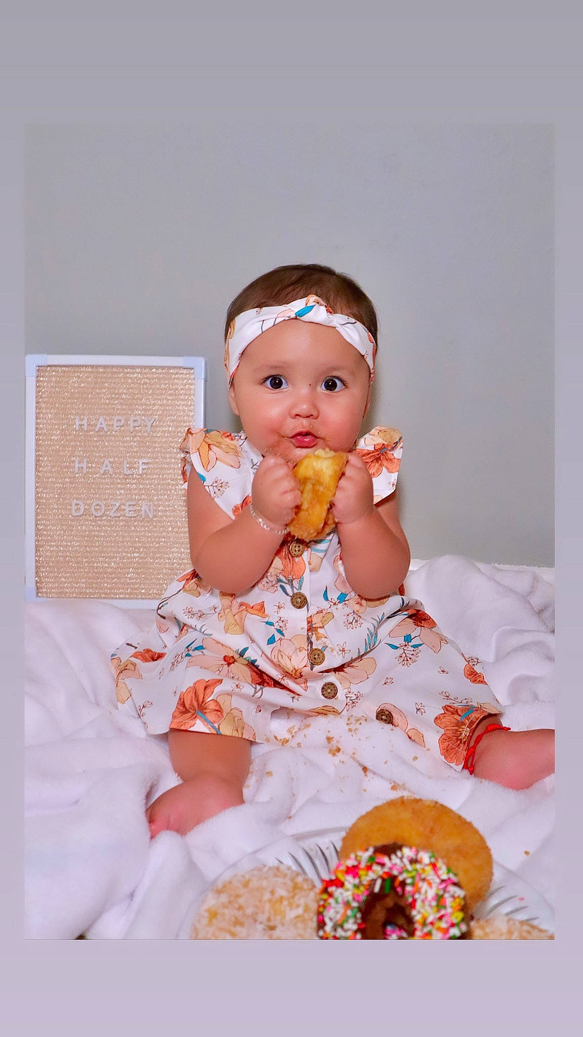 Layla is registered to the contest to win money with this photo: baby, baby_toddler_clothing, cheek, child, day_dress, dress, event, happy, headwear, nail, one_piece_garment, pattern, peach, person, pink, ruffle, sitting, skin, sleeve, sweetness