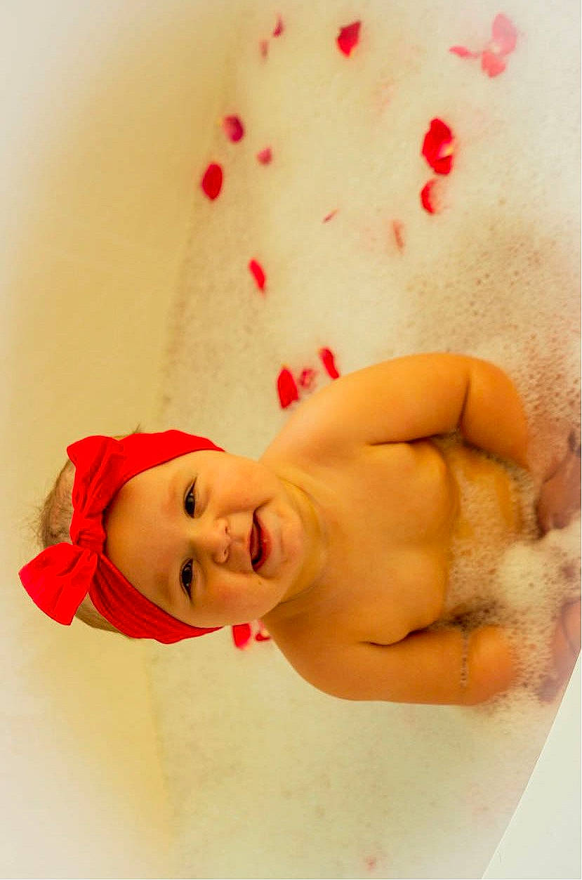 Paisley is registered to the contest to win money with this photo: arm, chest, chin, gesture, hairstyle, happy, head, headgear, headwear, human_body, joy, knee, lip, mouth, neck, person, shoulder, skin, smile, stomach