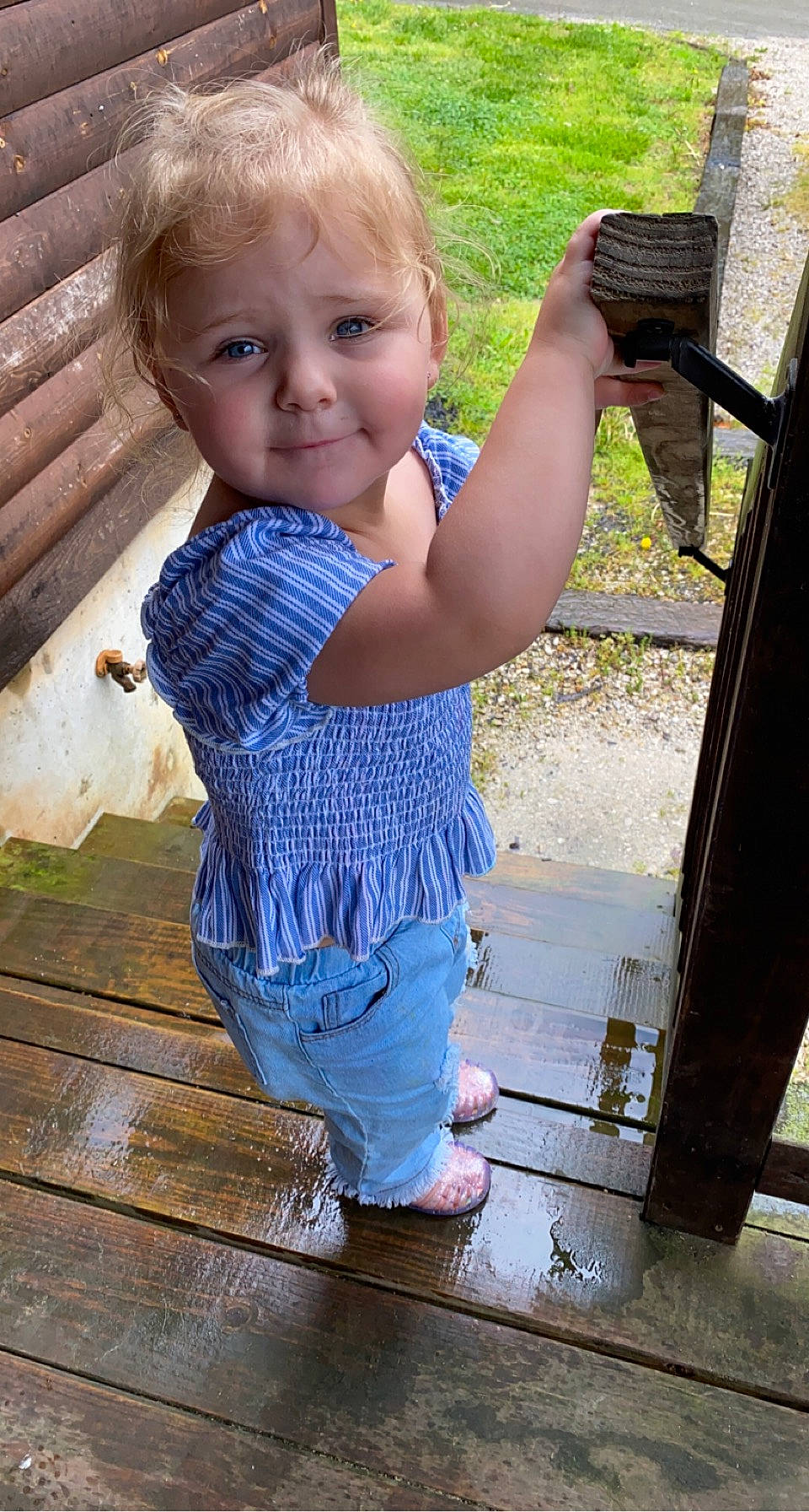 Amberlee is registered to the contest to win money with this photo: baby_toddler_clothing, beauty, blue, cheek, chin, eye, face, grass, hair, hand, happy, people_in_nature, person, photograph, skin, smile, standing, summer, toddler, window