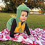 baby, child, dinosaur_costume, green, yellow, blanket, grass, outdoor, tree, crawling, costume, cute, infant, nature, park, play, sunset, portrait, person, fall