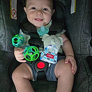 Jasiah joined the competition — help win amazing prizes! baby, infant, child, smiling, happy, car_seat, pacifier, toy, rattle, bib, elephant, diaper, seated, portrait, indoor, close_up, face, hands, baby_clothing, safety_harness