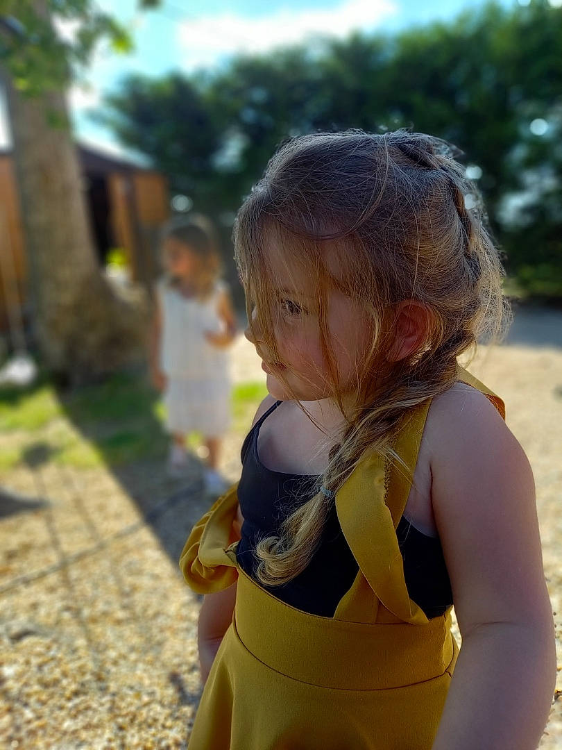 Mya participe au concours pour gagner de l'argent avec cette photo : child, doll, electric_blue, fun, grass, hair, happy, leisure, people_in_nature, person, recreation, sitting, skin, sky, summer, sunlight, toddler, toy, tree, trunk