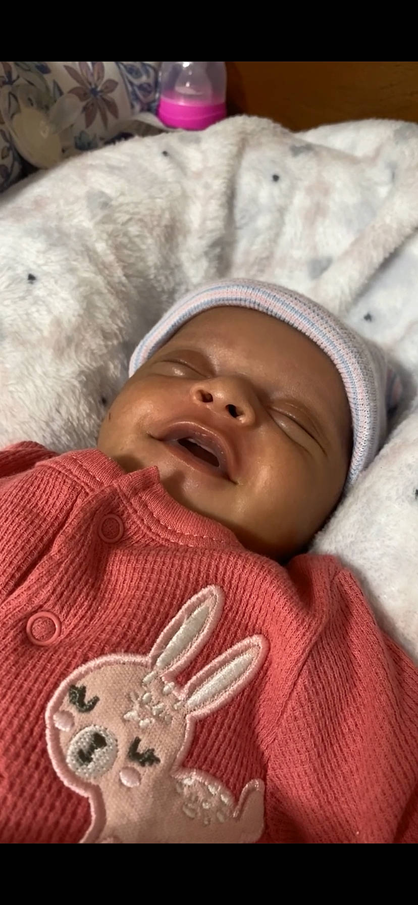 Karmen is registered to the contest to win money with this photo: baby, baby_toddler_clothing, cheek, chin, comfort, eye, happy, hat, headgear, linens, lip, mammal, mouth, nose, person, skin, smile, thumb, toddler, vertebrate