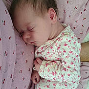 Dallas is registered to the contest to win money with this photo: baby, sleeping, infant, onesie, flamingo_pattern, pink_blanket, cherry_prints, cozy, cute, child, newborn, soft_fabric, resting, peaceful, portrait, close_up, indoors, comfort, person, toddler