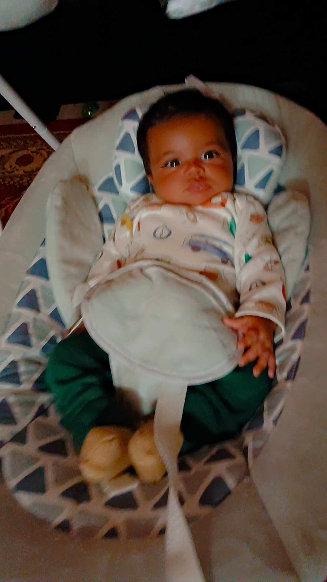 Zaylin is registered to the contest to win money with this photo: baby, infant, child, baby_seat, clothing, onesie, pants, footwear, face, eyes, hand, straps, pattern, indoor, carpet, furniture, comfort, cute, curious, portrait