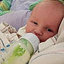 Micah joined the competition — help win amazing prizes! baby, bottle, feeding, blanket, infant, closeup, face, sleepy, soft, comfort, child, nursery, newborn, peaceful, indoor, person, cuddle, resting, fabric, head