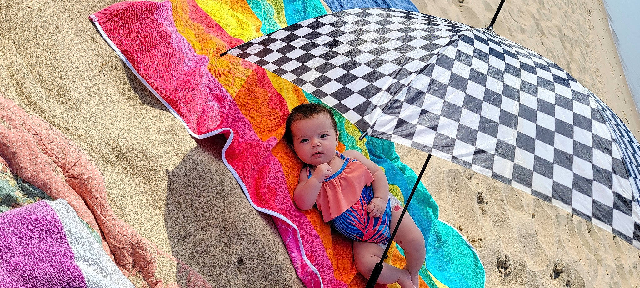 Esmae is registered to the contest to win money with this photo: baby, baby_products, chair, child, comfort, fashion_accessory, flooring, fun, leisure, linens, magenta, pattern, person, play, recreation, sitting, swimwear, textile, thigh, toddler