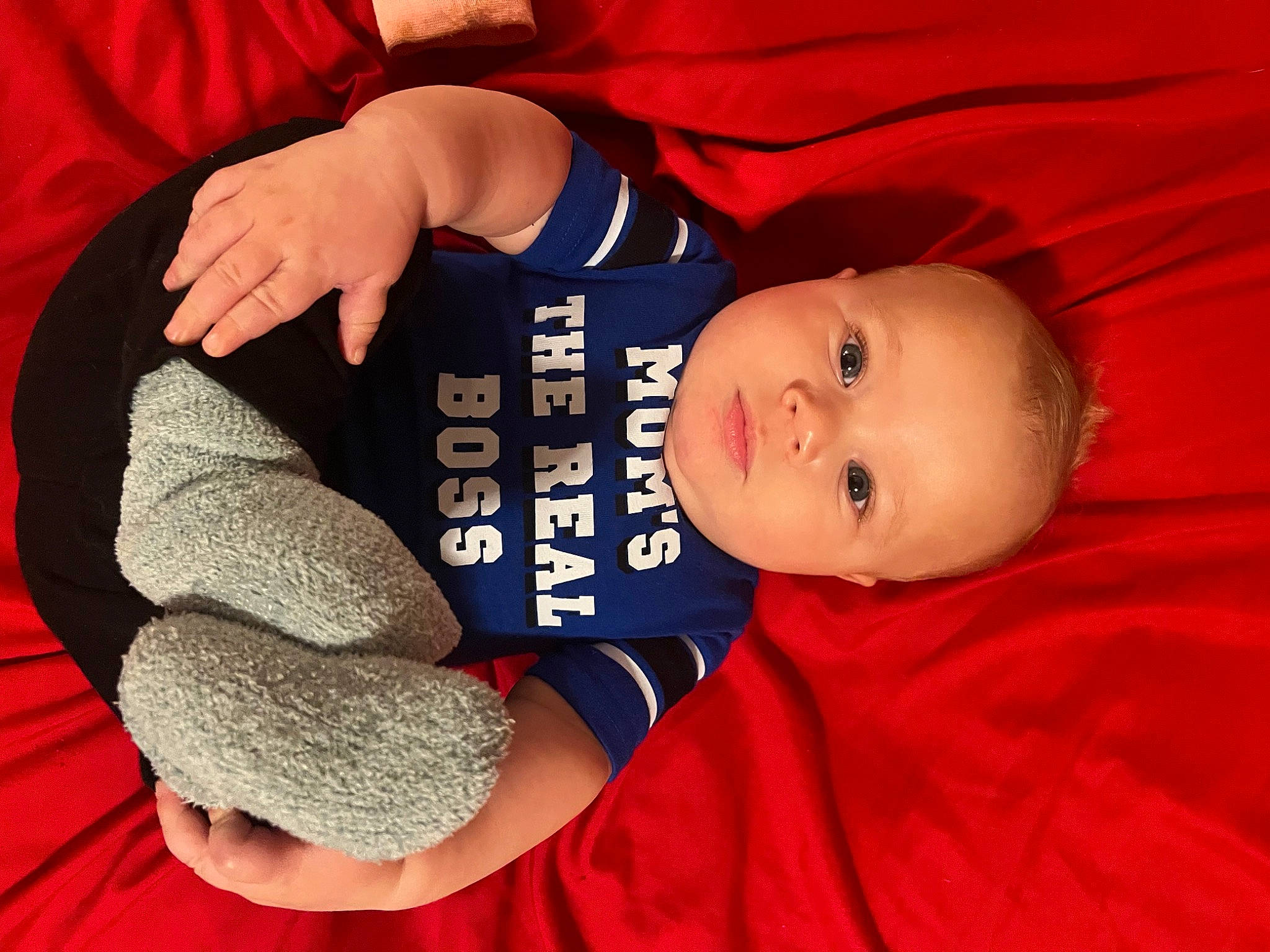 Shannon is registered to the contest to win money with this photo: baby, baby_toddler_clothing, carmine, child, comfort, elbow, electric_blue, finger, gesture, happy, nail, person, red, sitting, sleeve, smile, thread, thumb, toddler, wool