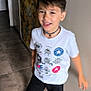 boy, casual, child, door, floor, hair, hallway, happy, home, indoor, motion_blur, movement, person, playful, shorts, smile, socks, tshirt, wall, young