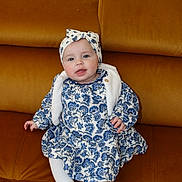 Loanne a rejoint le concours — aidez-le/la à gagner de superbes lots ! baby, blue_flower_pattern, child, comfortable, couch, cozy, cute, dress, fashion, furniture, happy, headband, indoors, infant, person, portrait, seated, smiling, white_tights, young_child