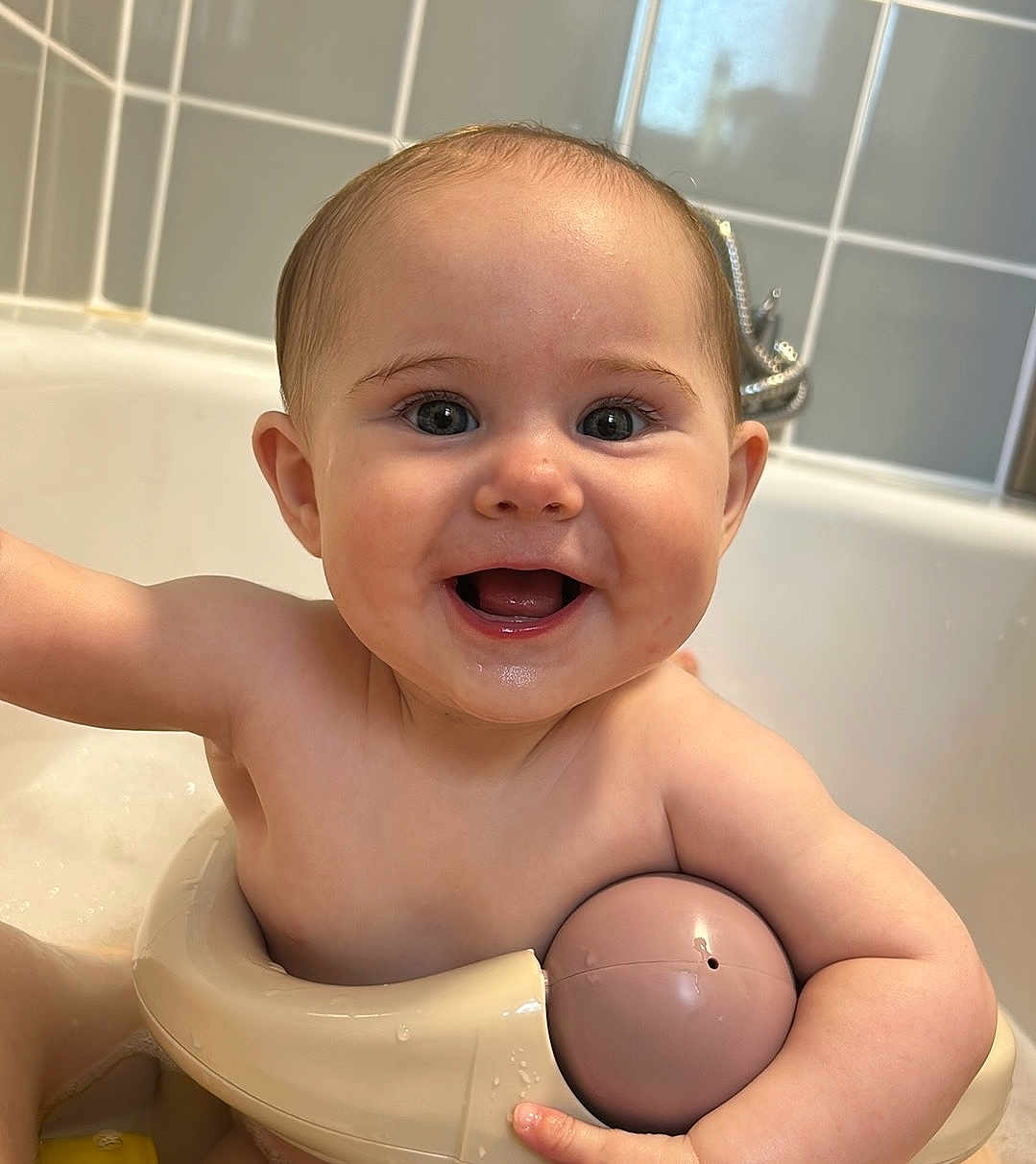 Elsie joined the competition — help win amazing prizes! baby, bath, bathtub, bathroom, child, smiling, toy, water, skin, face, happy, cute, infant, sitting, play, tiled_wall, faucet, arm, head, mouth