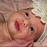 baby, infant, close_up, headband, flower, soft_skin, lying_down, pink_blanket, newborn, cute, portrait, face, child, small_hand, innocence, expression, young, adorable, skin, sleepy