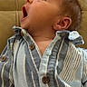 baby, infant, child, portrait, face, yawning, open_mouth, looking_up, striped_shirt, clothing, couch, indoors, home, seated, close_up, young_child, head, ear, brown_hair, casual