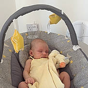 Harriet joined the competition — help win amazing prizes! baby, sleeping, infant, baby_swing, blanket, plush_toy, toddler, indoor, soft_toy, graco, yellow, gray, floor, carpet, child, peaceful, resting, cute, infant_clothing, baby_accessory