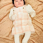 Riva joined the competition — help win amazing prizes! baby, infant, child, blanket, plaid, dress, white_tights, mittens, headband, soft_texture, laying_down, curious_expression, indoors, cute, young_child, portrait, warm_colors, cozy, fabric, sleepwear