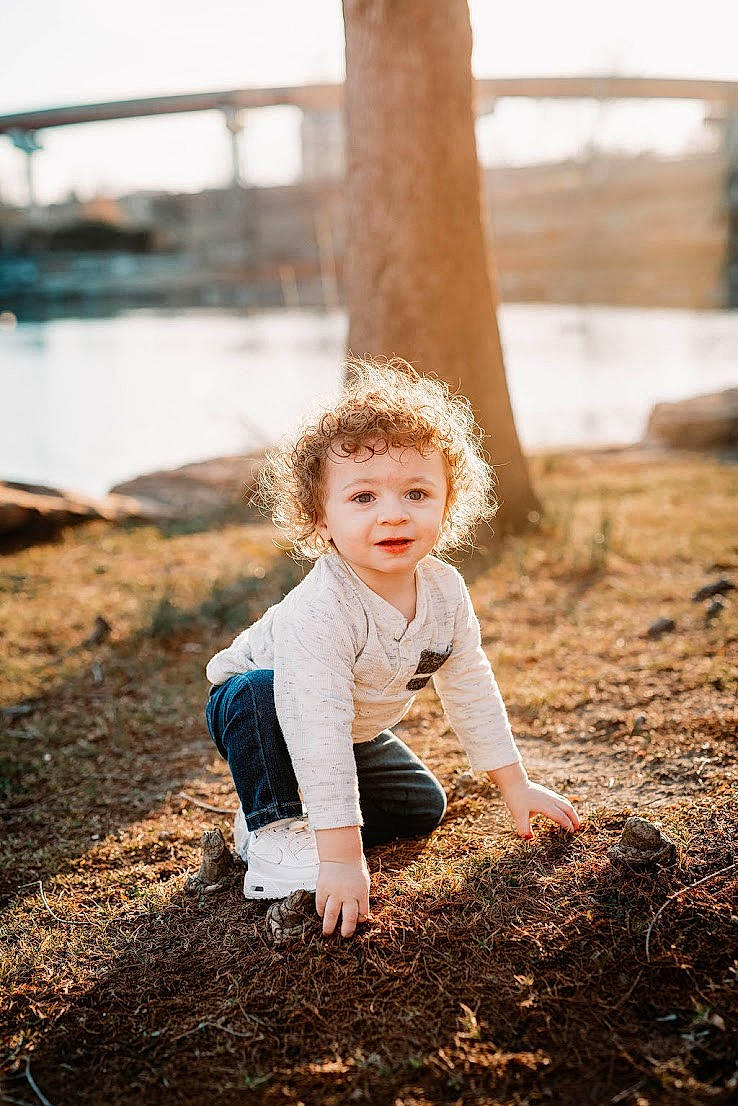 Julian is registered to the contest to win money with this photo: branch, brown_hair, child, flash_photography, forest, fun, grass, happy, landscape, people_in_nature, person, plant, sitting, sky, smile, soil, summer, sunlight, toddler, tree