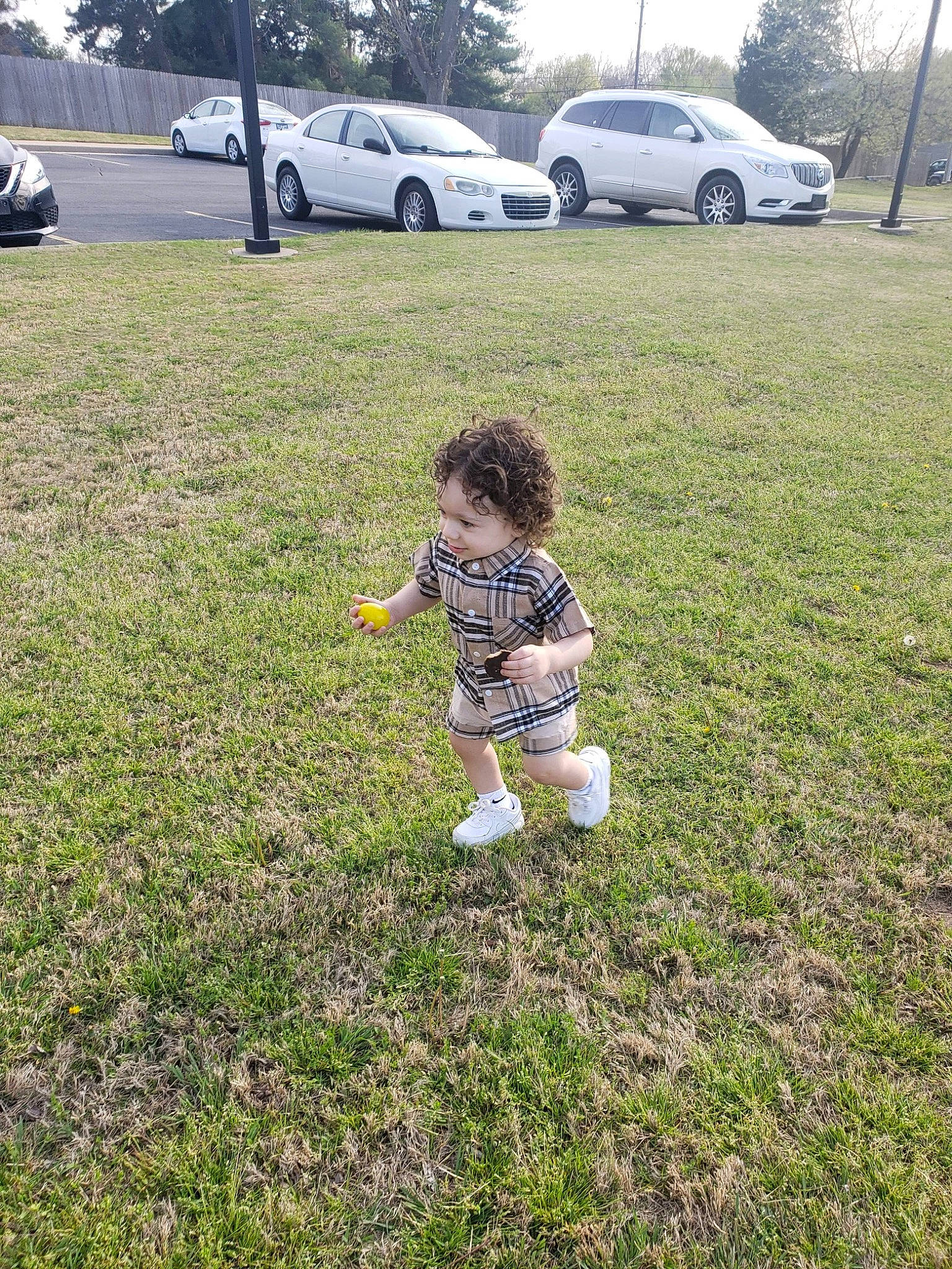 Julian is registered to the contest to win money with this photo: asphalt, automotive_exterior, automotive_tire, car, grass, grassland, land_vehicle, landscape, meadow, motor_vehicle, people_in_nature, person, plain, plant, sky, tire, toddler, tree, vehicle, vehicle_door