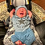 Damon joined the competition — help win amazing prizes! baby, infant, clothing, blue_outfit, hat, car_seat, patterned_rug, wood_floor, person, legs, feet, crying, stretching, indoor, casual, comfort, child, newborn, cute, relaxed
