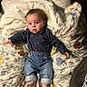 baby, barefoot, bed, blanket, casual_wear, child, clothing, curious, cute, expression, face, floral_pattern, indoors, jeans, person, portrait, shirt, skin, toddler, young_child