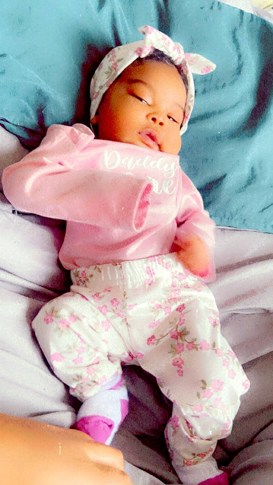 Keilani Bush joined the competition — help win amazing prizes! baby, baby_sleeping, baby_toddler_clothing, cheek, child, comfort, face, happy, head, linens, magenta, pattern, peach, person, pink, portrait_photography, sitting, skin, sleeve, textile