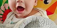 Jose joined the competition — help win amazing prizes! baby, child, blanket, smiling, face, mouth_open, cozy, indoors, colorful_background, cartoon, animal_illustration, happy, cute, head, person, portrait, soft_texture, wrapped, infant, toddler