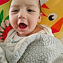 baby, child, blanket, smiling, face, mouth_open, cozy, indoors, colorful_background, cartoon, animal_illustration, happy, cute, head, person, portrait, soft_texture, wrapped, infant, toddler