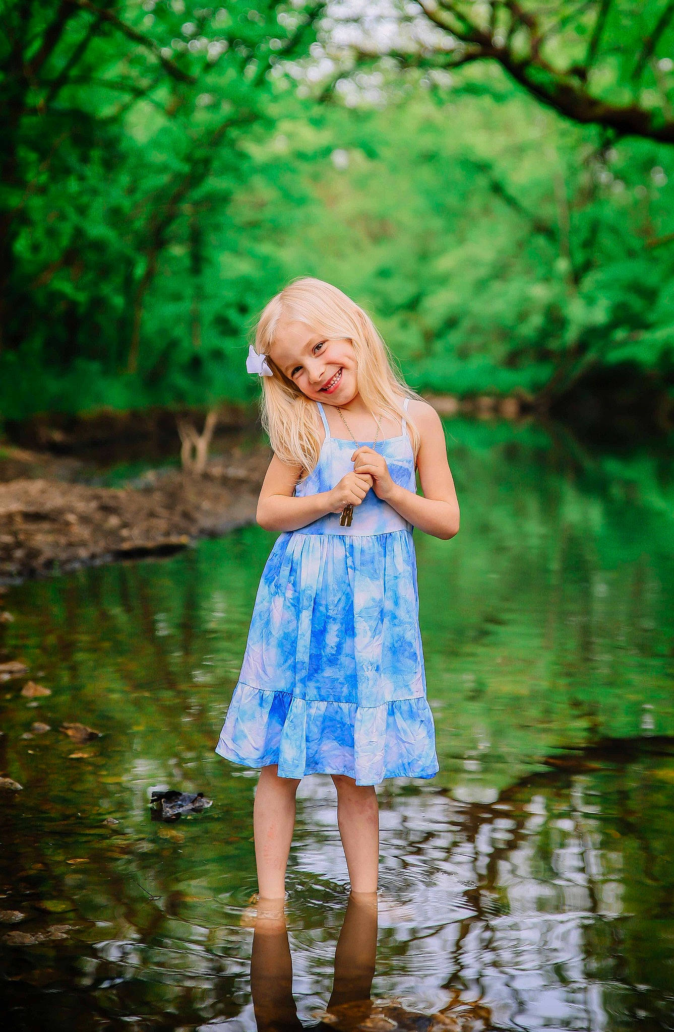 Mary is registered to the contest to win money with this photo: bank, branch, day_dress, dress, electric_blue, flash_photography, forest, grass, green, happy, joy, leisure, long_hair, one_piece_garment, people_in_nature, person, plant, street_fashion, tree, water