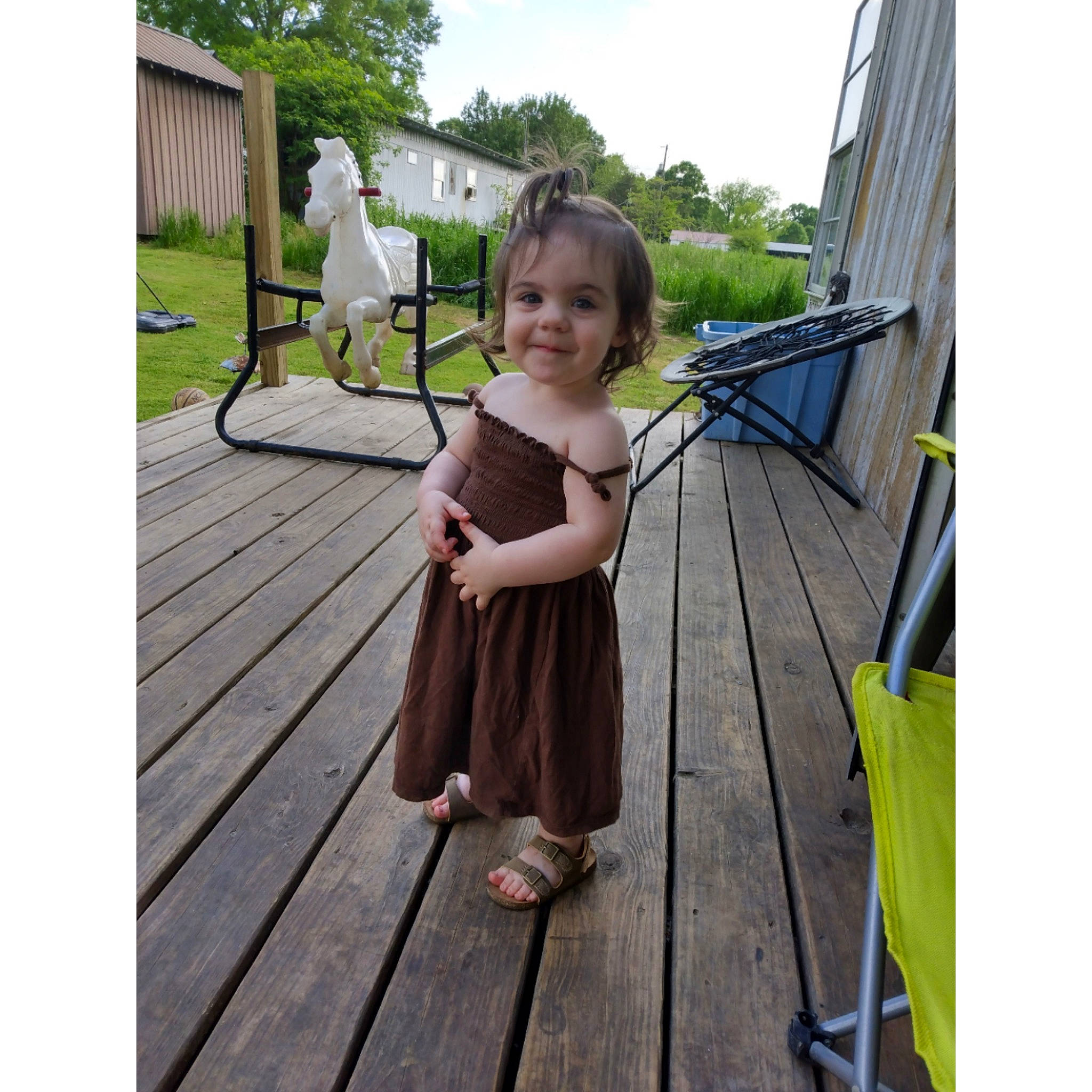 Aubrey joined the competition — help win amazing prizes! deck, design, dress, flooring, fun, grass, happy, hardwood, joy, leisure, outdoor_furniture, person, plant, product, recreation, sitting, sky, smile, toddler, tree