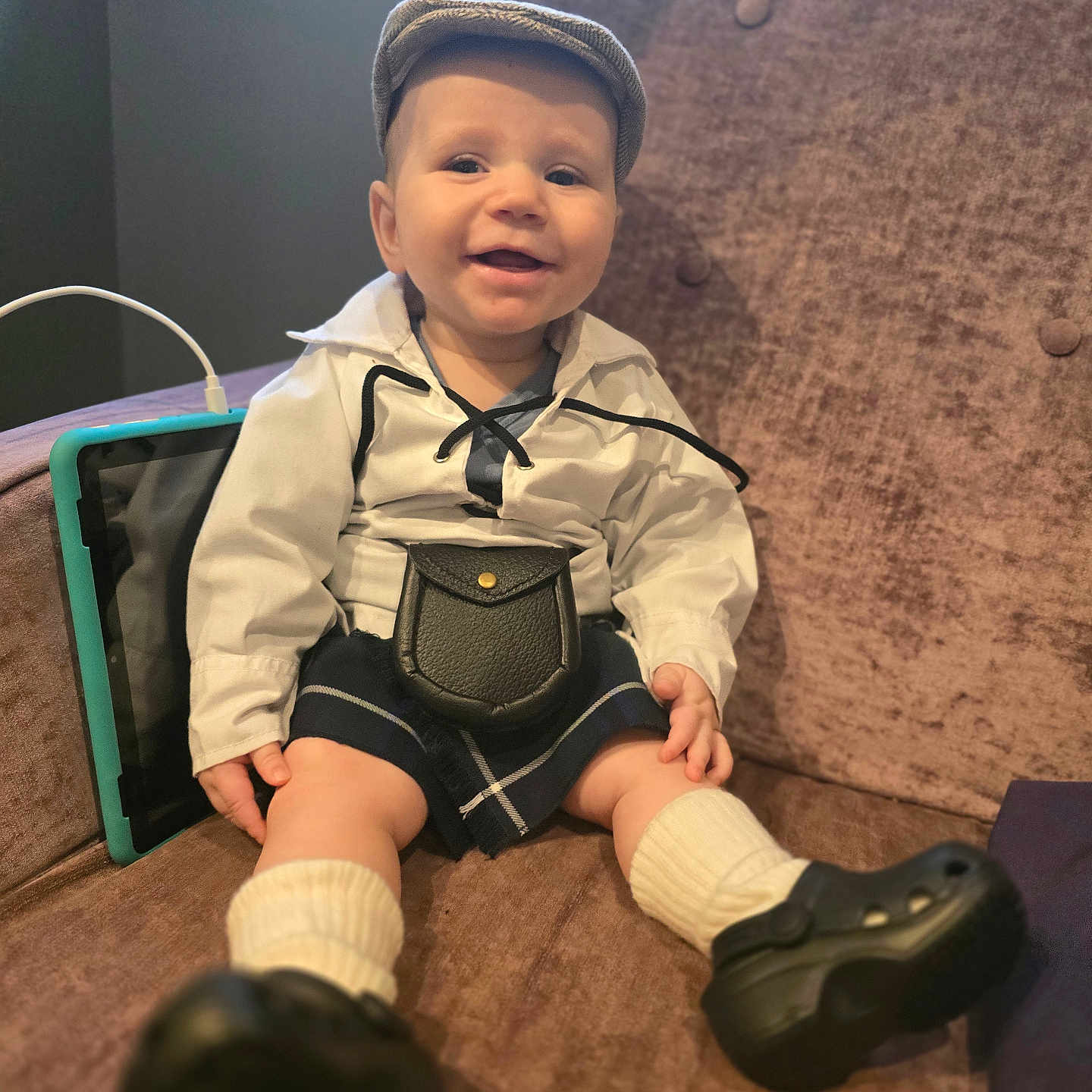 Dylan is registered to the contest to win money with this photo: accessories, baseballcap, boy, cap, child, clothing, face, footwear, formalwear, hat, head, male, pants, person, photography, portrait, shoe, shorts, sitting, tie