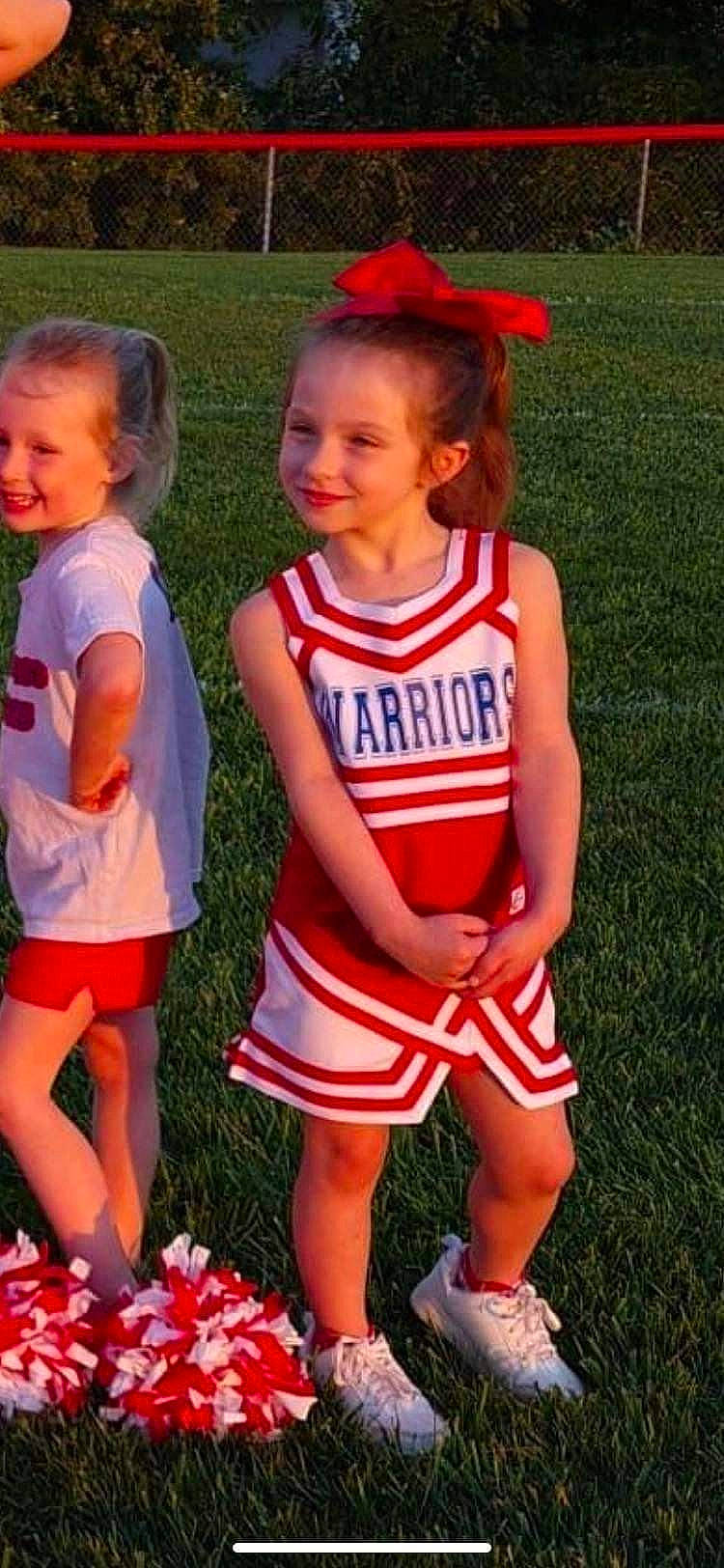 Harbor is registered to the contest to win money with this photo: cheerleading, cheerleading_uniform, gesture, grass, hair, happy, jersey, joy, person, player, red, shoe, shorts, smile, sports, sports_uniform, sportswear, t_shirt, team, team_sport