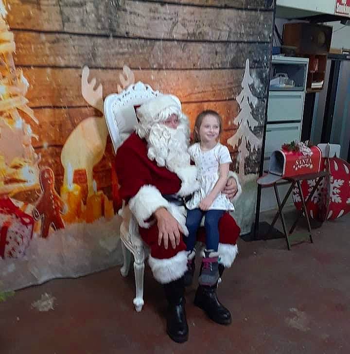 Harbor is registered to the contest to win money with this photo: baby, blurred, chair, christmas, christmas_eve, costume, event, fictional_character, fun, fur, hat, holiday, joy, lap, leisure, person, room, santa_claus, sitting, toddler