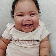 Xamira Hutcheson joined the competition — help win amazing prizes! baby, child, smiling, happy, cute, infant, chubby, hair, face, skin, sitting, onesie, clothing, hand, legs, white_background, joy, portrait, indoor, closeup