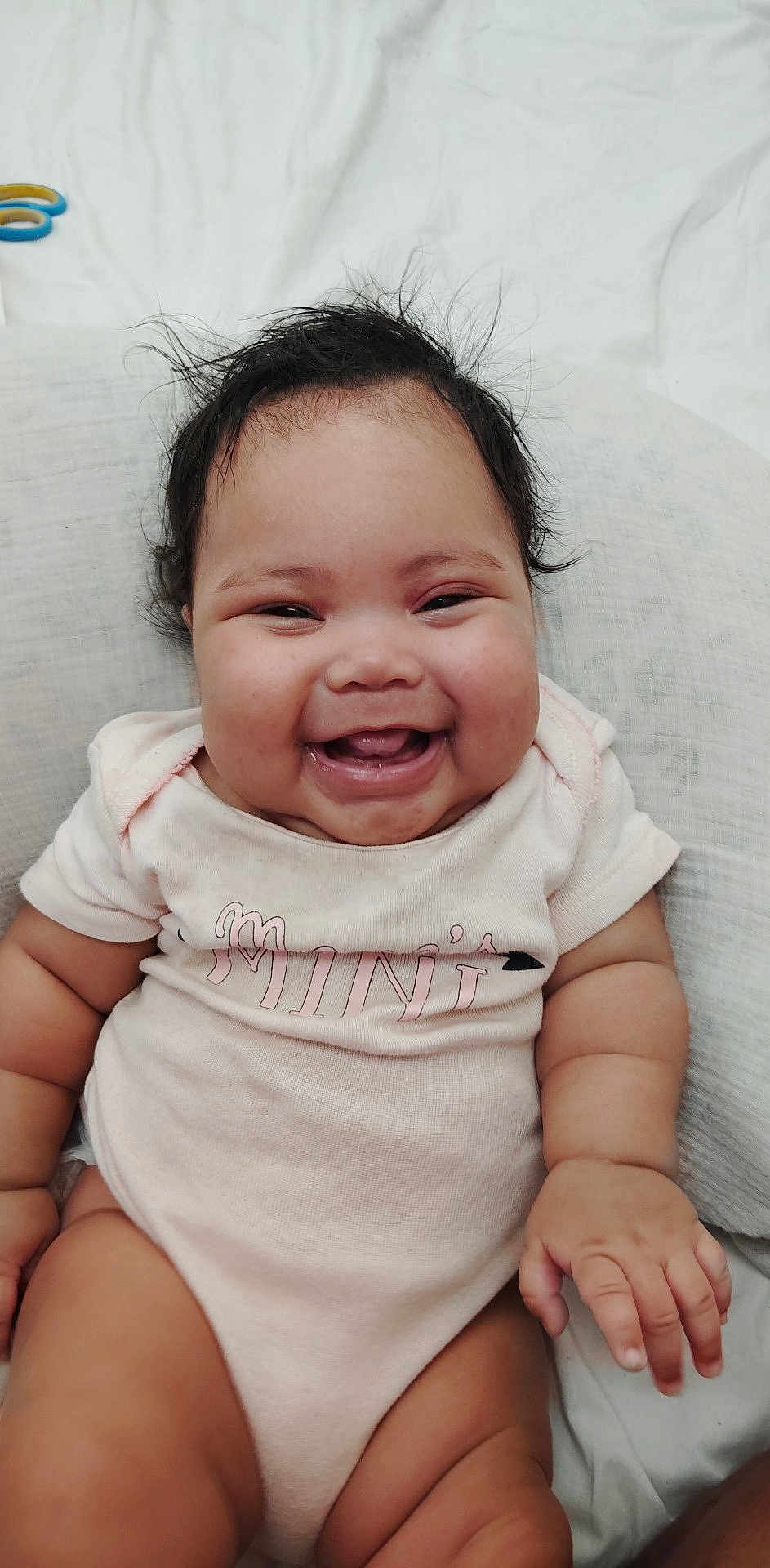 Xamira Hutcheson joined the competition — help win amazing prizes! baby, child, smiling, happy, cute, infant, chubby, hair, face, skin, sitting, onesie, clothing, hand, legs, white_background, joy, portrait, indoor, closeup
