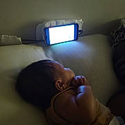 Xamira joined the competition — help win amazing prizes! adult, baby, bed, cable, clothing, dark, device, dim_light, hand, indoor, infant, person, pillow, quiet, resting, side_view, skin, sleeping, smartphone, wall