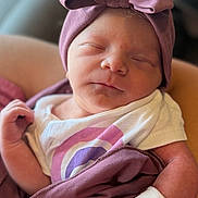 Callie joined the competition — help win amazing prizes! newborn, baby, sleeping, headwrap, bow, blanket, hospital_wristband, arm, person, clothing, purple, white, infant, cute, peaceful, skin, portrait, indoors, closeup, resting