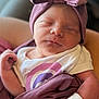 newborn, baby, sleeping, headwrap, bow, blanket, hospital_wristband, arm, person, clothing, purple, white, infant, cute, peaceful, skin, portrait, indoors, closeup, resting