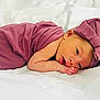 Callie joined the competition — help win amazing prizes! newborn, baby, infant, purple_clothing, headband, bow, sleeping, resting, white_bed, soft, cute, portrait, child, wrapped, peaceful, skin, face, hand, lying_down, closeup