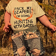 Nora joined the competition — help win amazing prizes! baby, infant, child, hat, pants, shirt, clothing, lying_down, blanket, patterned, cute, wide_eyes, indoor, cozy, soft_lighting, playful, expression, human, newborn, footwear