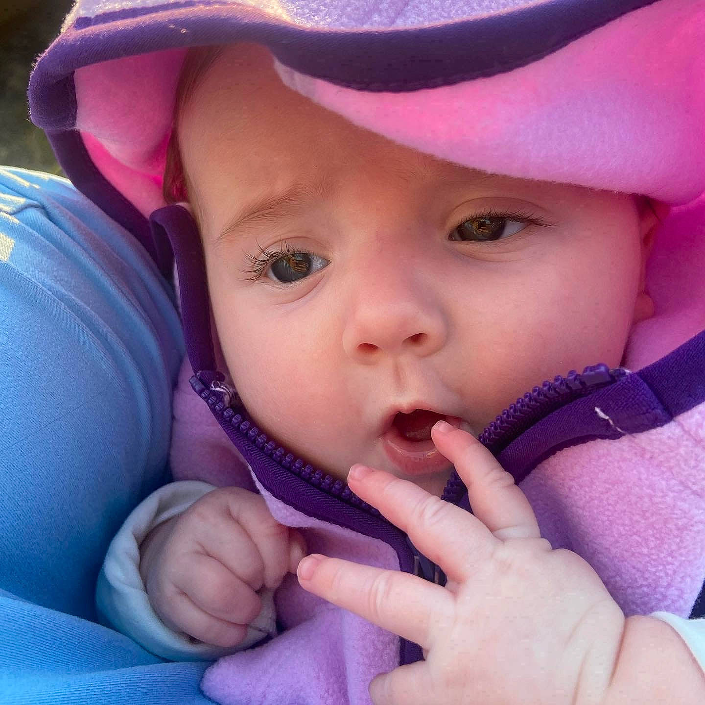 Ivey is registered to the contest to win money with this photo: baby, cap, cheek, chin, eye, eyebrow, eyelash, face, finger, gesture, hand, happy, headwear, iris, lip, mouth, nose, person, pink, product