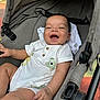 baby, child, stroller, smiling, laughing, onesie, white_clothing, infant, seat, fabric, cute, happy, outdoor, person, portrait, hand, leg, head, baby_clothes, comfort