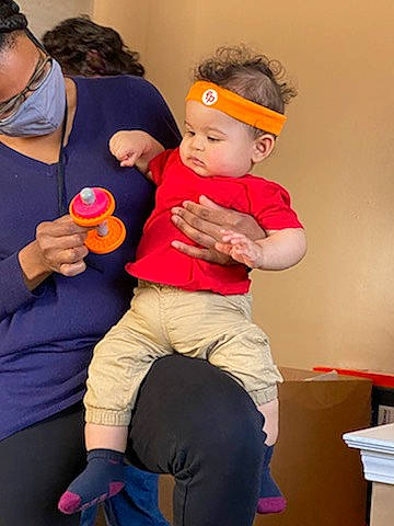 Bronson is registered to the contest to win money with this photo: belt, cap, child, event, fun, gesture, happy, hat, headwear, human_body, knee, leisure, magenta, person, pink, room, shorts, shoulder, sitting, t_shirt