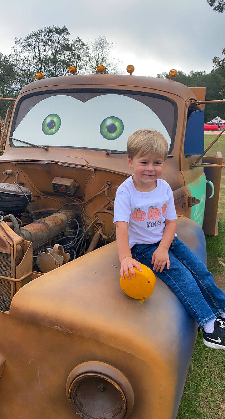 Kole is registered to the contest to win money with this photo: auto_part, automotive_design, car, child, joy, motor_vehicle, person, toddler, vehicle
