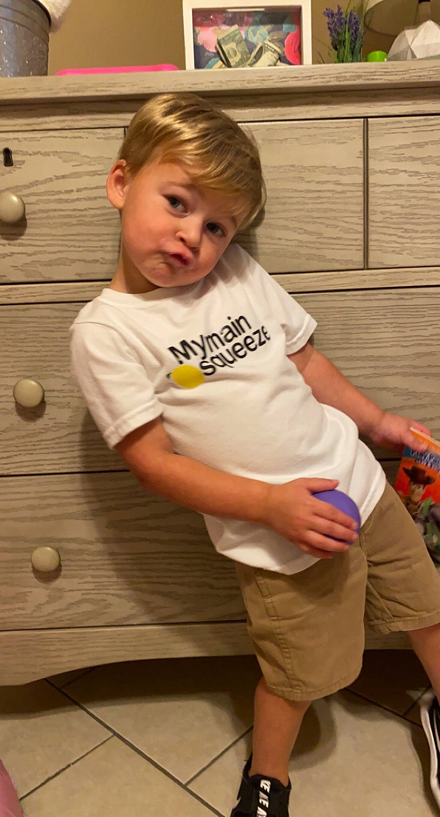 Kole is registered to the contest to win money with this photo: arm, child, leg, person, play, sitting, t_shirt, toddler, wood