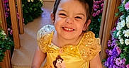 Natalie joined the competition — help win amazing prizes! child, smiling, yellow_dress, princess_costume, flowers, aisle, indoor, happy, cute, portrait, girl, celebration, costume, young, colorful, decorative, fun, joy, event, person