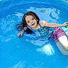 Natalie joined the competition — help win amazing prizes! child, pool, water, swimwear, outdoor, summer, happy, smile, playful, blue, kiddie_pool, sitting, girl, sunlight, reflection, wet_hair, nature, grass, relaxing, fun